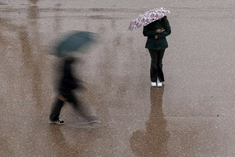 Dos personas se protegen con paraguas de la lluvia, en una imagen de archivo. EFEBiel Alio
