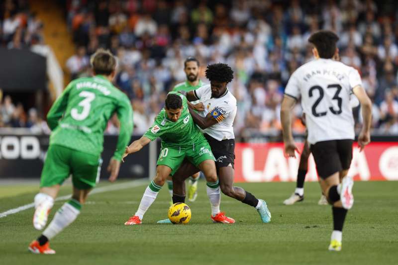 El defensa portugués del Valencia Thierry Correia (d) disputa un balón ante el delantero del Betis Ayoze Pérez. EFE/ Biel Alino