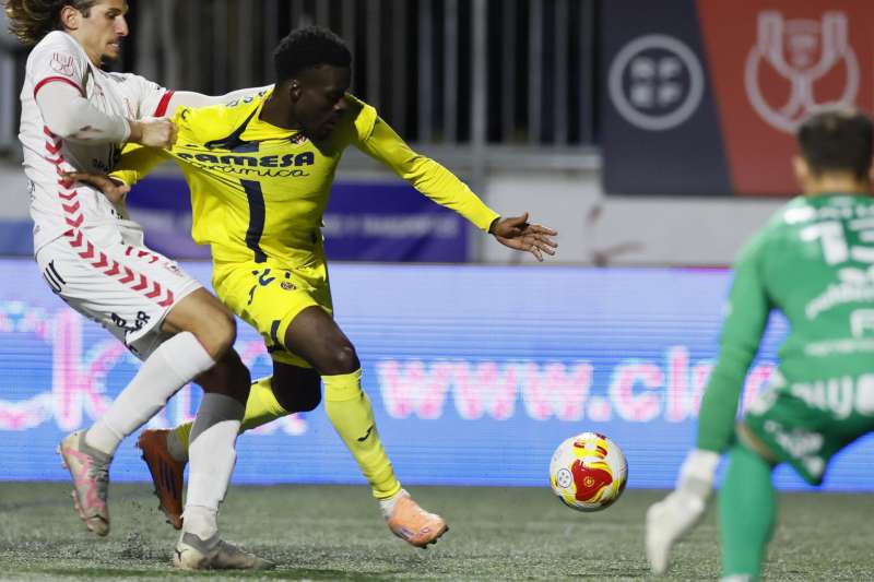 El delantero canadiense del Villarreal, Tani Oluwaseyi (d), intenta llevarse el balón ante el defensor del Antoniano. EFE/José Manuel Vidal