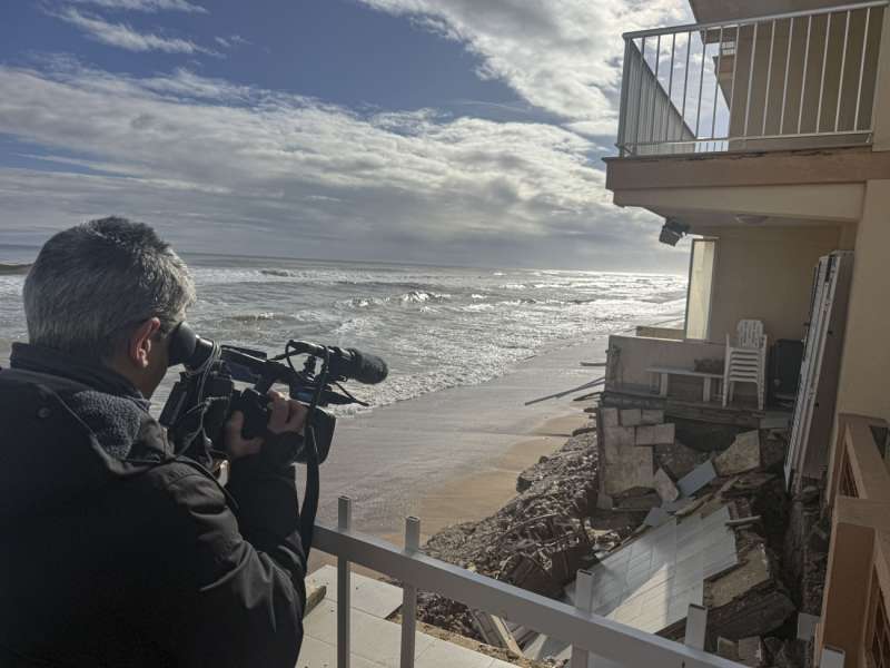 En la imagen un cámara graba los destrozo causados por el temporal en un edificio situado frente a la playa de Tavernes de Valldigna. EFE/Manuel Bruque En la imagen un cámara graba los destrozo causados por el temporal en un edificio situado frente a la playa de Tavernes de Valldigna. EFE/Manuel Bruque