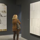 Una mujer observa una obra de la exposición Carrara, en la sala de la Glorieta de Sagunt.