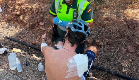 Agente de la Guardia Civil atienden a uno de los ciclistas heridos tras la caída múltiple durante la prueba en Estivella./ Guardia Civil