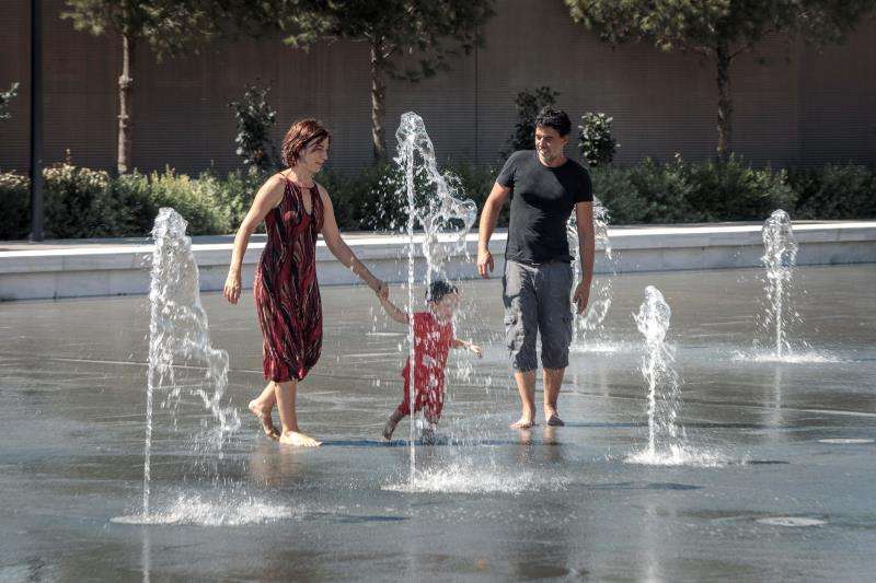 Una familia se refresca en una fuente del Parque Central de València en uno de los calurosos días registrados en la ciudad este agosto. EFE/Archivo